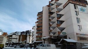 A multi-story hotel with balconies, a central column, and a sign for 'Hotel de Ville.' - VAL Thorens Rental: Studio for 4 People With Beautiful View (Les Belleville)