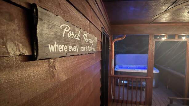 A wooden porch with a sign reading "Porch Therapy where every hour is happy hour." - Honey Bear Hideway - Hot Tub - Close to Blue Ridge and Ellijay (Ellijay)