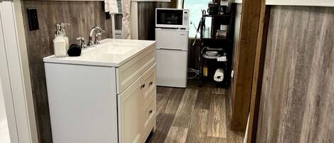 Coffee/tea maker, fridge, cookware/dishes/utensils