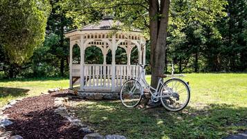 A gazebo with a bicycle parked in front.