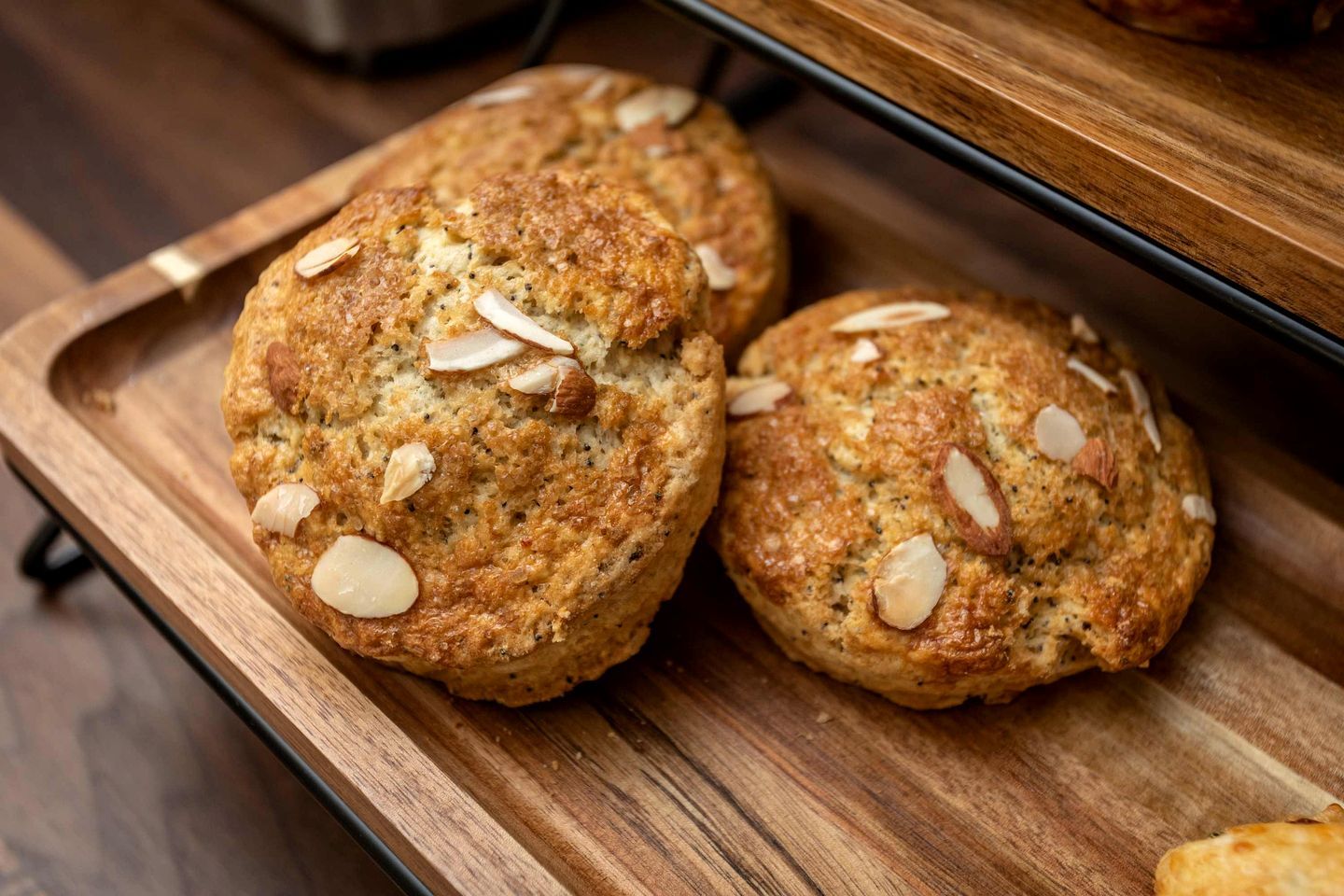 Three muffins on a wooden tray.