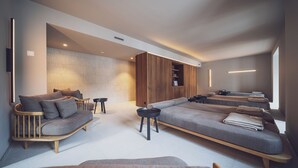 A modern, well-lit living room with a sofa, chairs, and a coffee table. - Hotel Joseph's House (Davos)