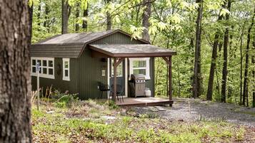 A cabin with a porch, a grill, and a number '536' on the door.