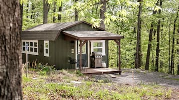 A cabin with a porch, a grill, and a number '536' on the door.