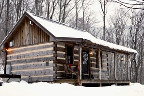 A log cabin with a porch, a door, and a window. - Rustic Wooden Cabin with Hot-tub in Riverton, West Virginia (Riverton)