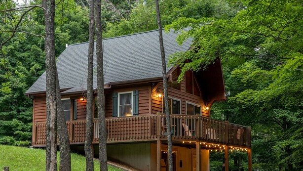 A cabin with a deck, surrounded by trees. - Secluded West Virginia Cabin Rental on the Edge of Monongahela National Forest (Riverton)