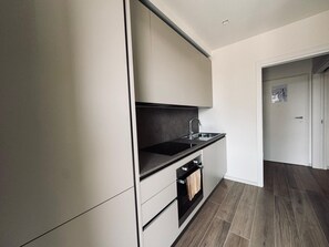 Een oven, een kookplaat, een vaatwasser, kookgerei, borden en bestek