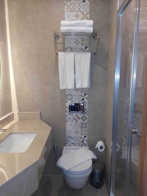 A bathroom with a shower, toilet, and sink. - Four Sides Beyoglu (Istanbul)