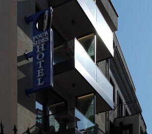 A hotel sign indicating 'Four Sides Hotel' with a modern architectural style featuring balconies and large windows. - Four Sides Beyoglu (Istanbul)