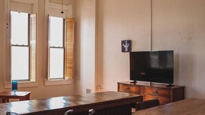 A kitchen with a wooden countertop, a sink, and a television on a wooden cabinet. - 15% off Spring Special | Historic Bank | Wi-Fi | Close to Purdue (Oxford)