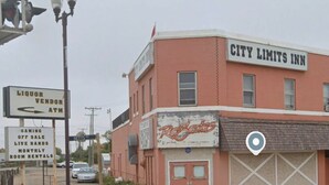 A building with a sign for 'CITY LIMITS INN' and another sign for 'Liquor Vendor ATM' on the left. - City Limits Inn Hotel (Yorkton)
