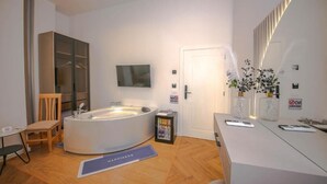 A modern bathroom with a freestanding bathtub, a vanity with a mirror, and a door with a 'No Smoking' sign. - Murati Lake View Hotel (Farkë)
