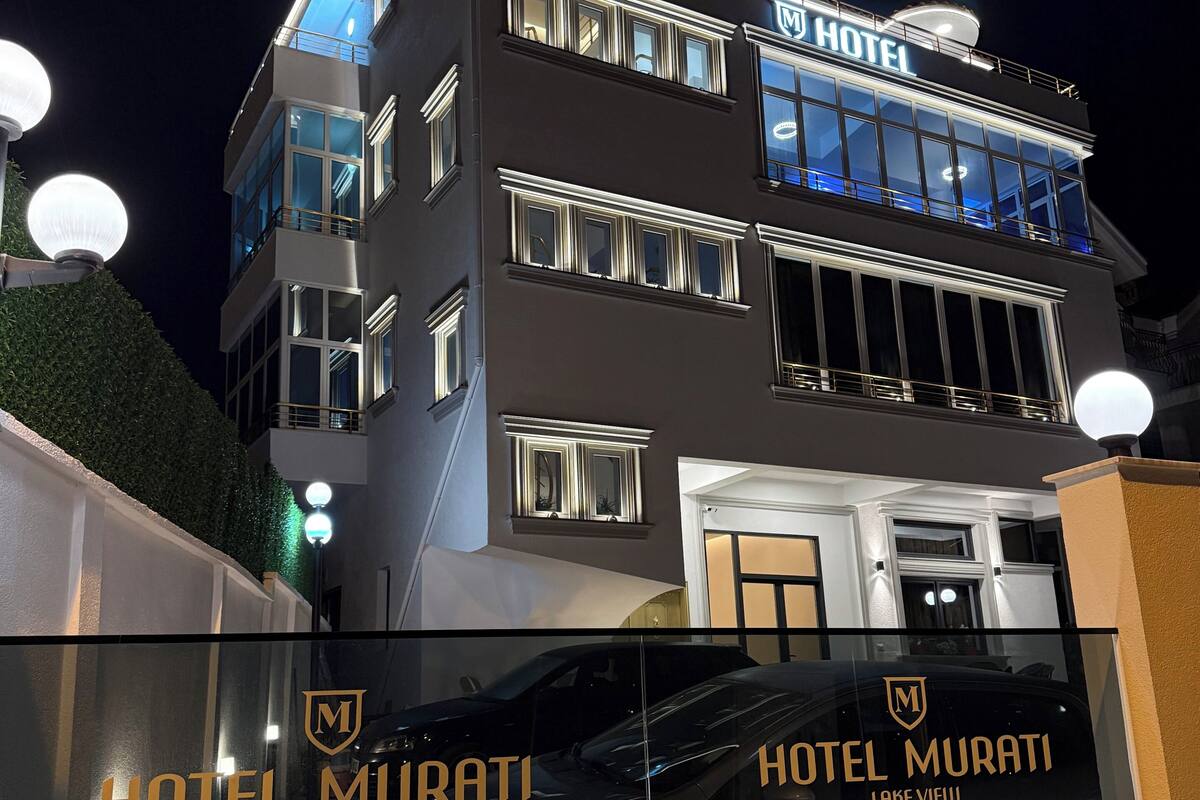 A multi-story hotel with a prominent 'HOTEL' sign on the top.