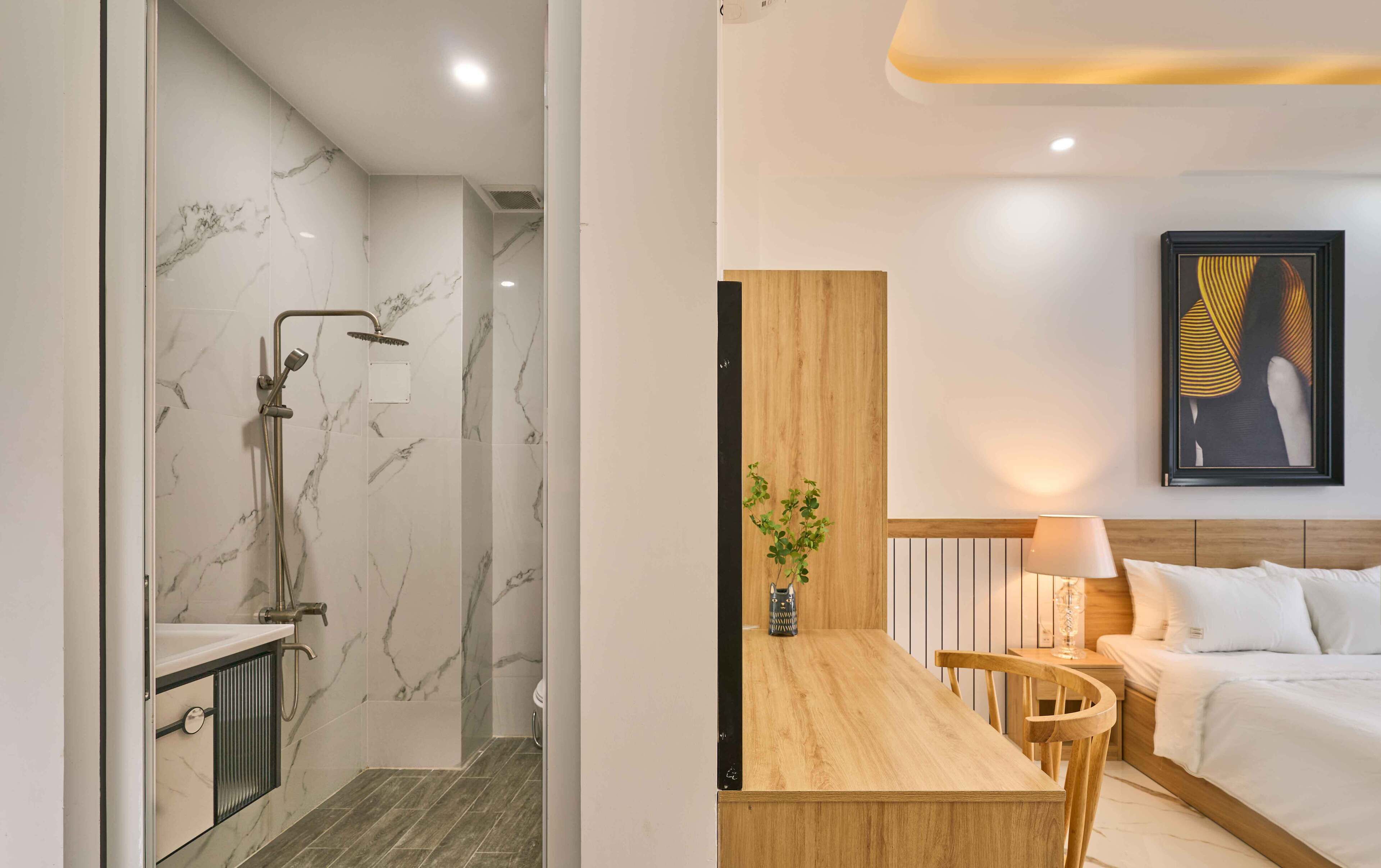 A modern bathroom with a shower and a wooden dining area with a table and chairs.