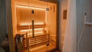 A sauna with wooden benches, a bench with a bowl, and a glass door. - Gîte "Gîte Du Pré Simon" with Private Garden and Wi-Fi (Le Faulq)