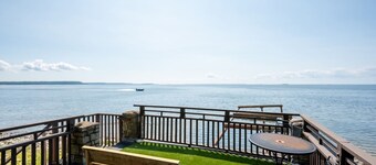 Sister Bay waterfront cabin surrounded by nature with kayaks, boathouse deck, and game room