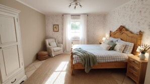 A bedroom with a wooden bed, a chair, a nightstand, and a wardrobe. - Apartment on a horse farm, children and pets welcome, garden & terrasse, grill (Lichtenau)