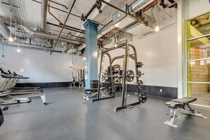 A gym with treadmills, weight machines, and a squat rack. - Modern West Loop Gem-City Views & Prime Location 4 (Chicago)