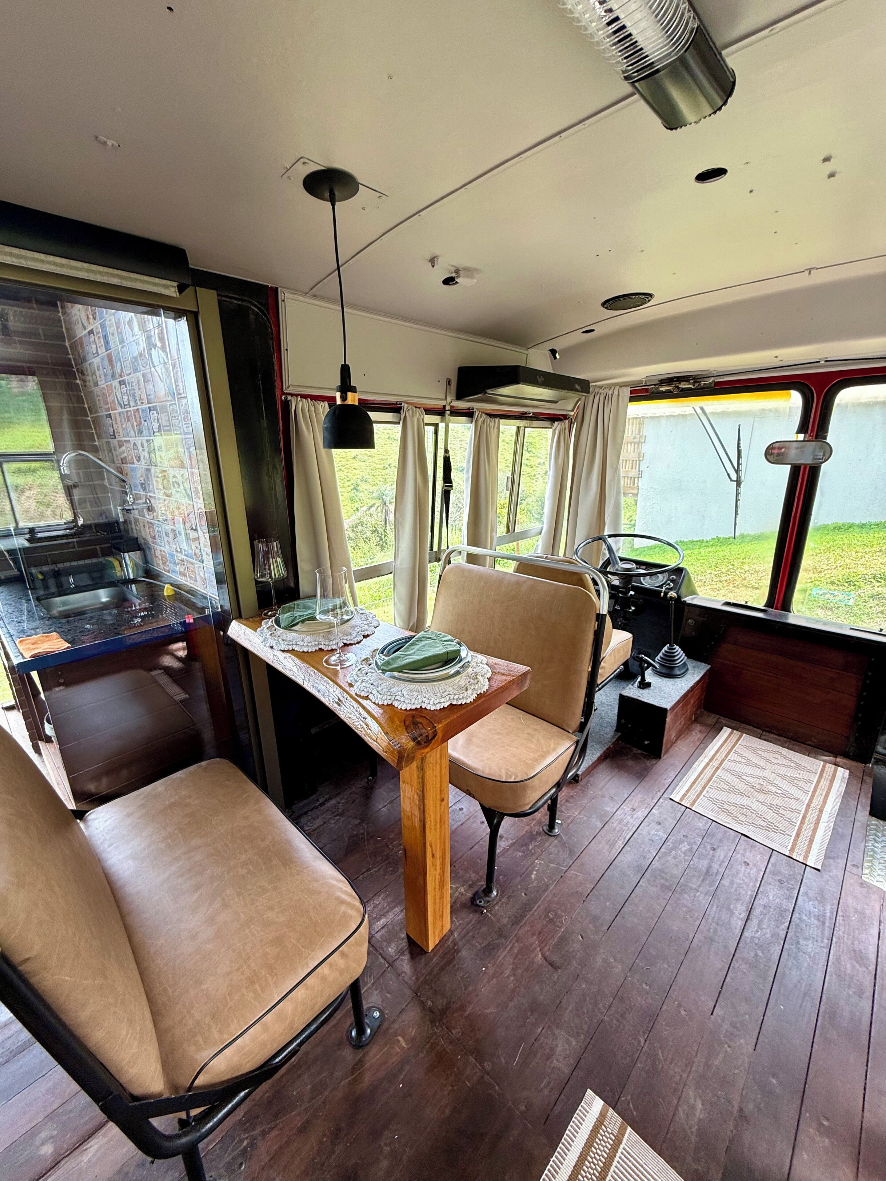 A compact kitchen with a dining table, chairs, and a small island.