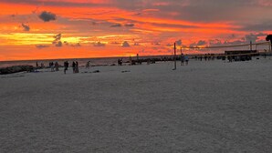 A beach with a volleyball net and people playing. - The Love Shack is a remodeled and roomy 2 BR house in fabulous St. Pete Beach (St. Pete Beach)