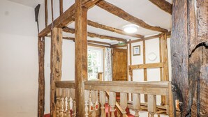 A wooden staircase with a red carpet, a wooden railing, and a white ceiling. - Chilton Manor House (Sittingbourne)