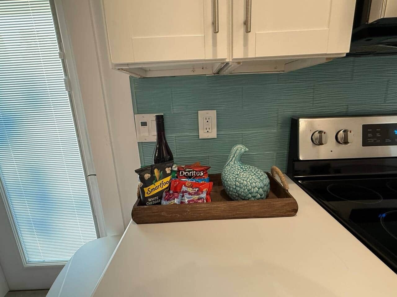A kitchen counter with a tray holding snacks and condiments.