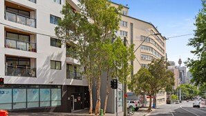 A modern building with multiple floors, large windows, and balconies. - Ideal Studio Inner-city Pad With Private Balcony (Sydney)