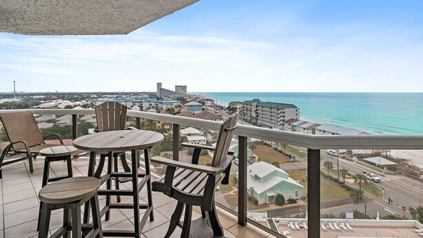 A balcony with a view of the ocean and a cityscape. - 9th Floor! Awesome Views! Free Beach SRVC! Free Beach Bonfires M & Fri Nights (Miramar Beach)