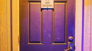 A door with a sign indicating a Yurt Bathroom. - Romantic Yurt | Cowboy Pool | Hot Tub| Near Wine (Driftwood)