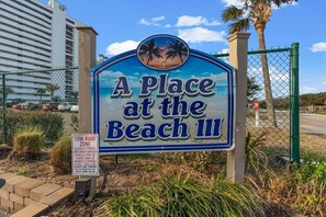 A sign for 'A Place at the Beach III' with a 'TOW AWAY ZONE' notice. - Oceanfront Shore Drive. Steps to Sand. King Suite + Balcony Views. APATBIII (Myrtle Beach)