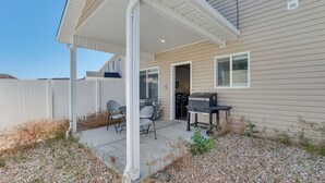 A covered patio area with a grill and seating. - 25 Mi to Cedar Breaks: Unit w/ Furnished Patio! (Cedar City)