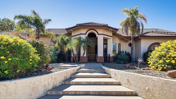 A house with a front entrance, steps leading up to it, and a garden with various plants and flowers. - Groups Welcome! Home w/ Pool + Patio in N Phoenix (Phoenix)