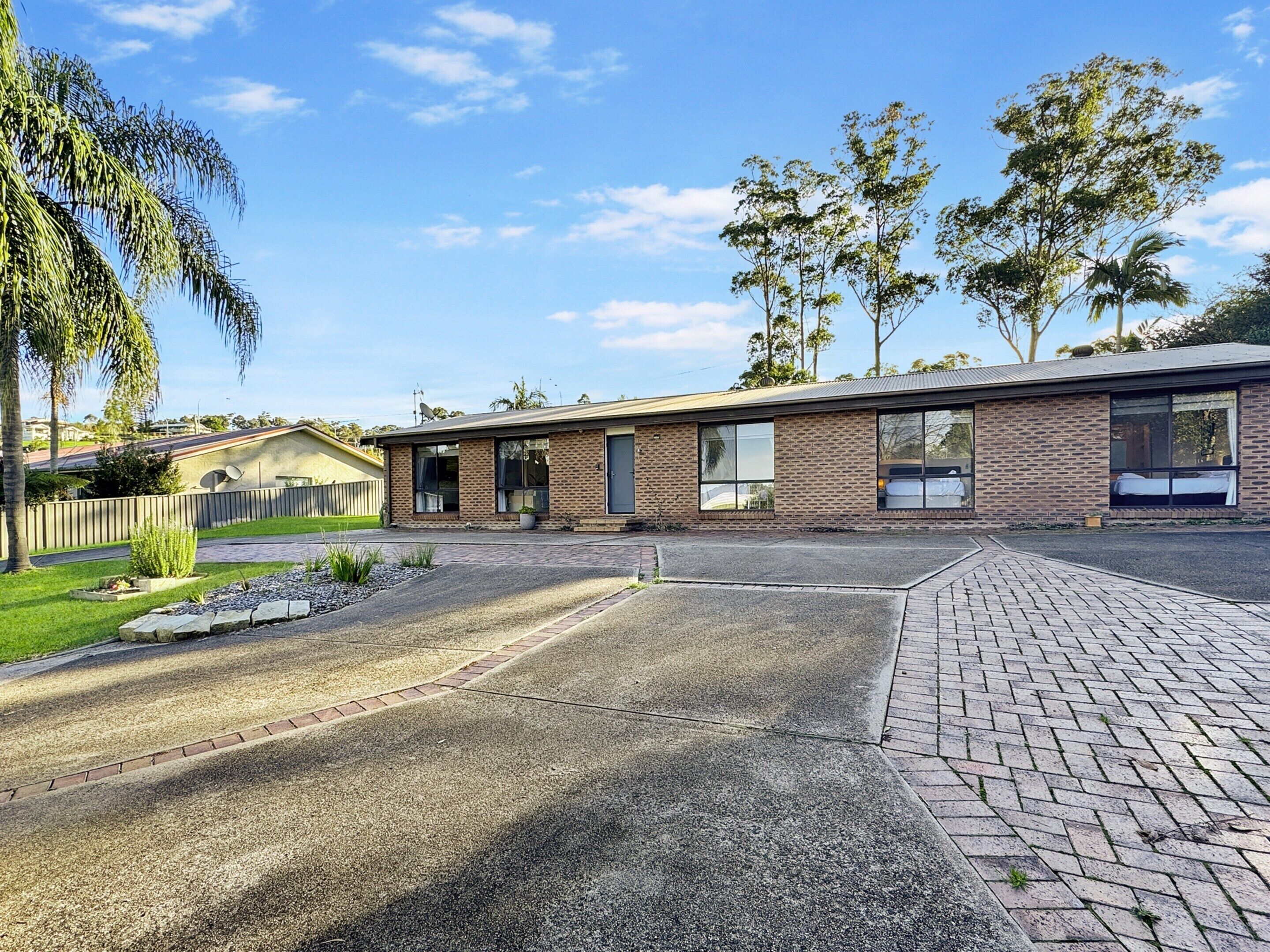 A single-story brick building with large windows and a flat roof.