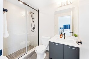 Shower, hair dryer, soap, toilet paper