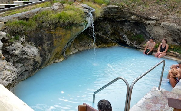 A natural hot spring with a small waterfall, surrounded by rocky terrain and greenery. - New built, stunning home with Hot Tub, 5/4, near Granby Ranch - sleeps 16 (Granby)