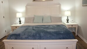 A bedroom with a bed, two bedside tables, and lamps. - Time to relax and enjoy (New Bern)