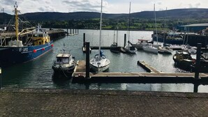 A marina with boats docked, a large ship on the left, and a bridge in the background. - Warrenpoint Centre, Town House Co. Down
Perfect to explore Carlingford Lough (Warrenpoint)