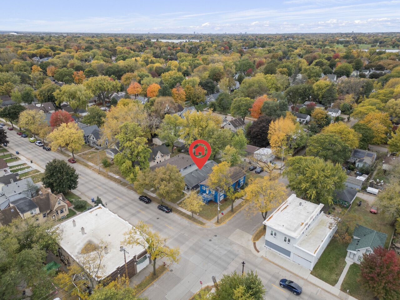An aerial view of a residential area with houses, streets, and trees.