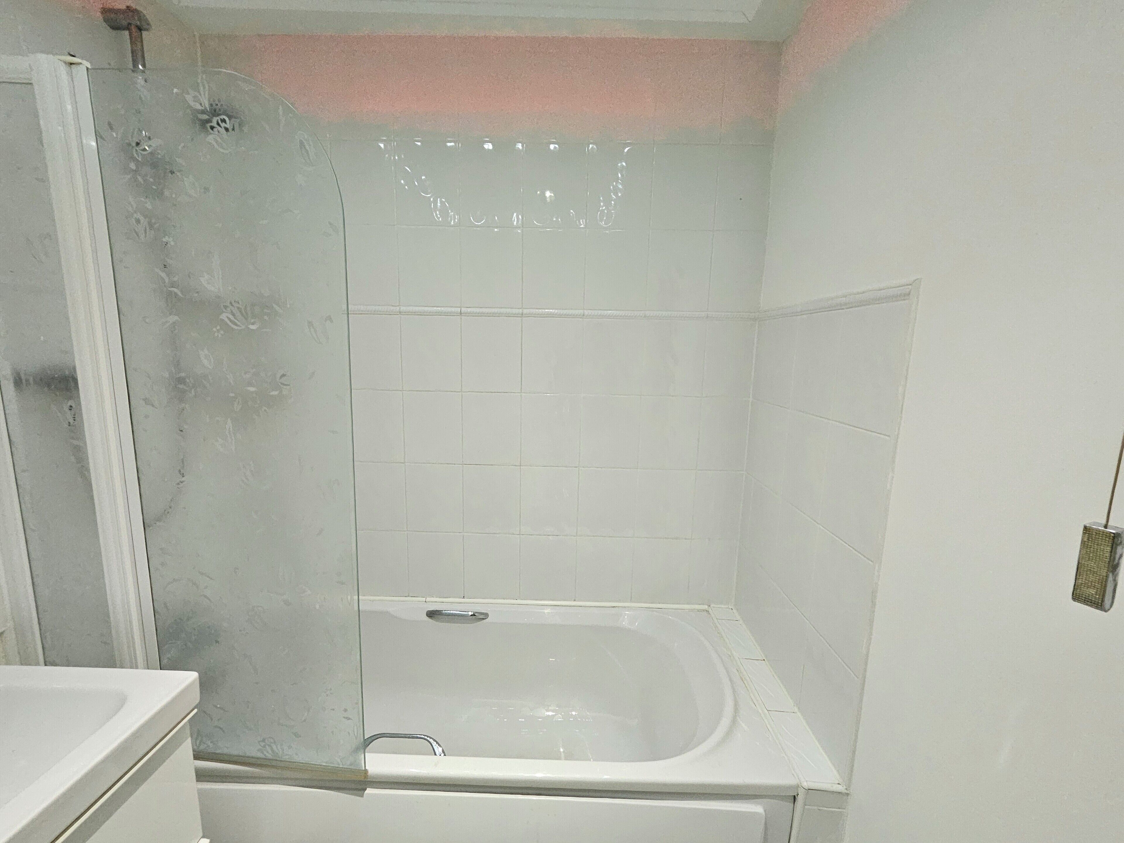 A bathroom with a shower, a bathtub, and a toilet.