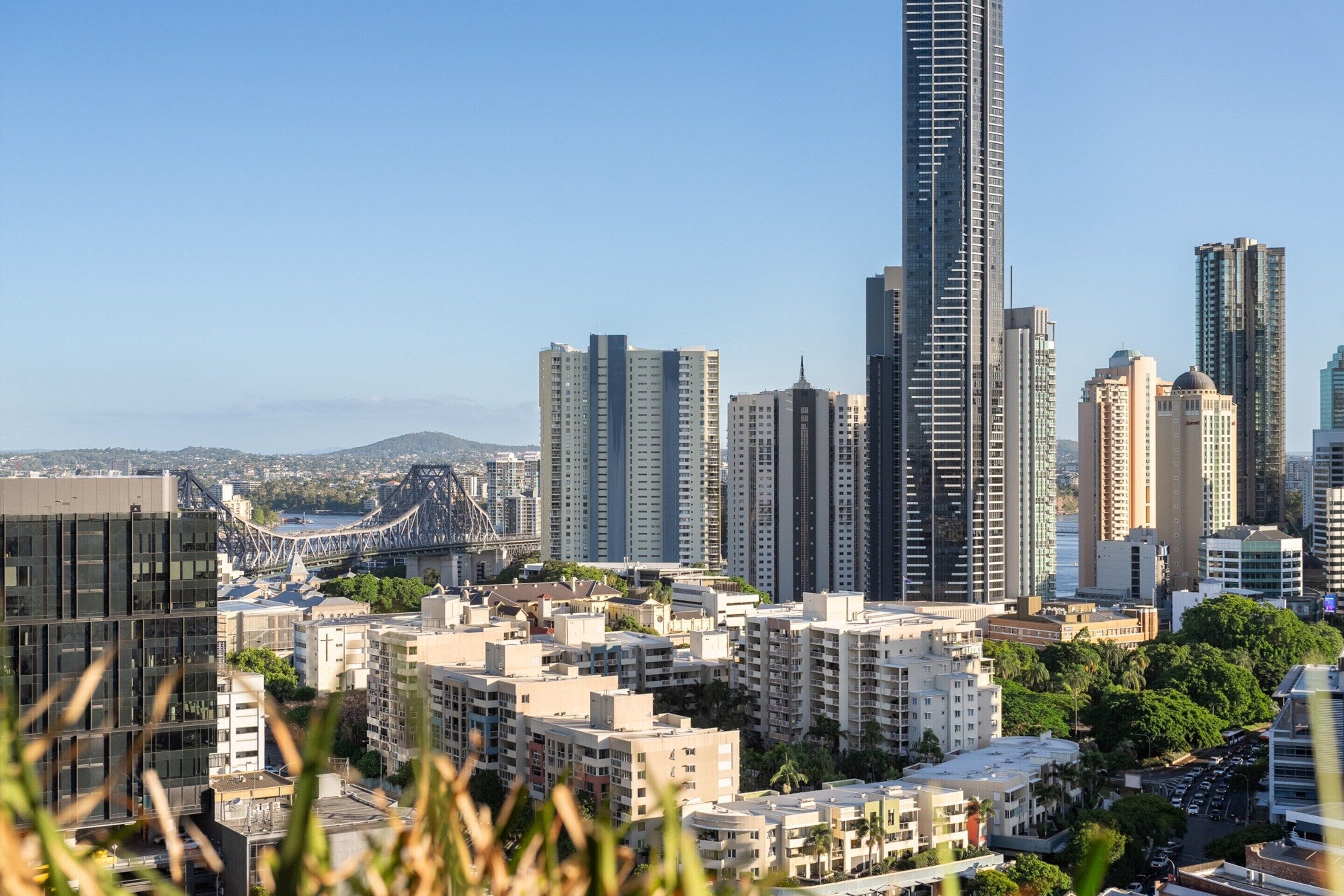 A cityscape with high-rise buildings, a bridge, and a mix of residential and commercial structures.