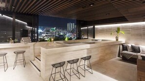 A modern bar area with a city view, wooden ceiling, and minimalist furniture. - City Escape With Balcony & Resort-style Amenities (Brisbane)