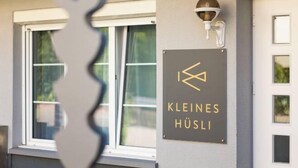 Une enseigne avec l’inscription « KLEINES HÜSLI » sur la façade d’un immeuble.