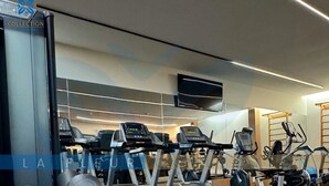 A gym with treadmills, elliptical machines, and weightlifting equipment. - Luxury Sea Front Foot on the Sand at La Fleur Polynesia (Porto de Galinhas)