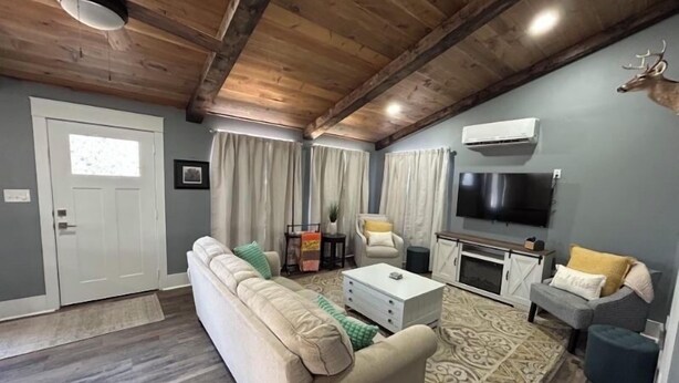 A living room with a sofa, coffee table, TV, and a fireplace.