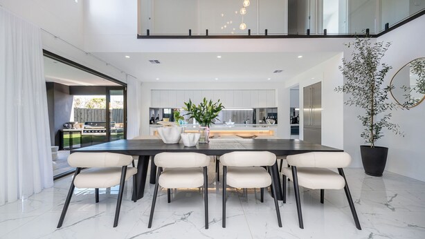 A modern kitchen with a central island, white cabinetry, and stainless steel appliances. - Villa Capri | Luxe Modern by the Village (Mount Eliza)