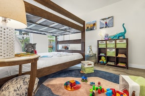 A child's bedroom with a bunk bed, a bookshelf, and a play area with toys and building blocks. - Family-Friendly Retreat | Walk to Gondola, Town & Amenities (Telluride)