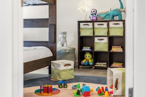 A child's bedroom with a bed, toys, and a bookshelf. - Family-Friendly Retreat | Walk to Gondola, Town & Amenities (Telluride)