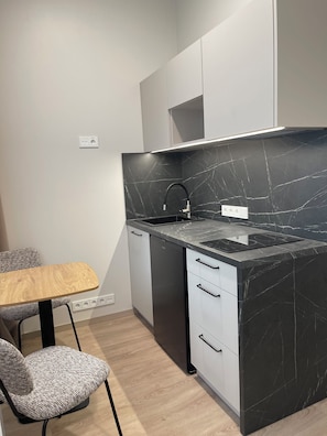 Mini-fridge, microwave, stovetop, cookware/dishes/utensils