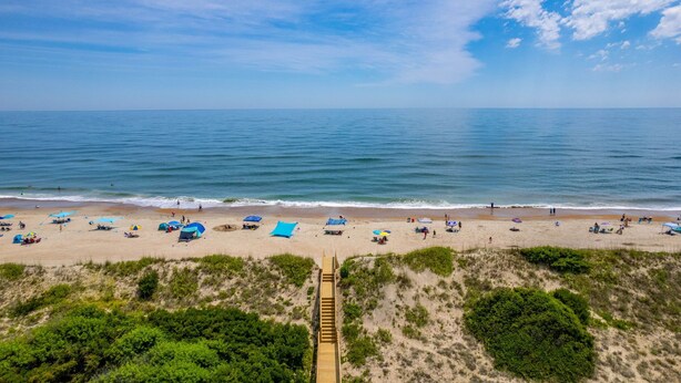 A beach with a wooden walkway leading to the shore, sandy beach, and clear blue sky. - Salty Blue Hen: Oceanside, Community Pool, Close to Beach Access (Corolla)