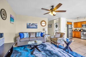 A living room with a sofa, coffee table, and a ceiling fan. - Recently updated oceanview retreat (Kihei)
